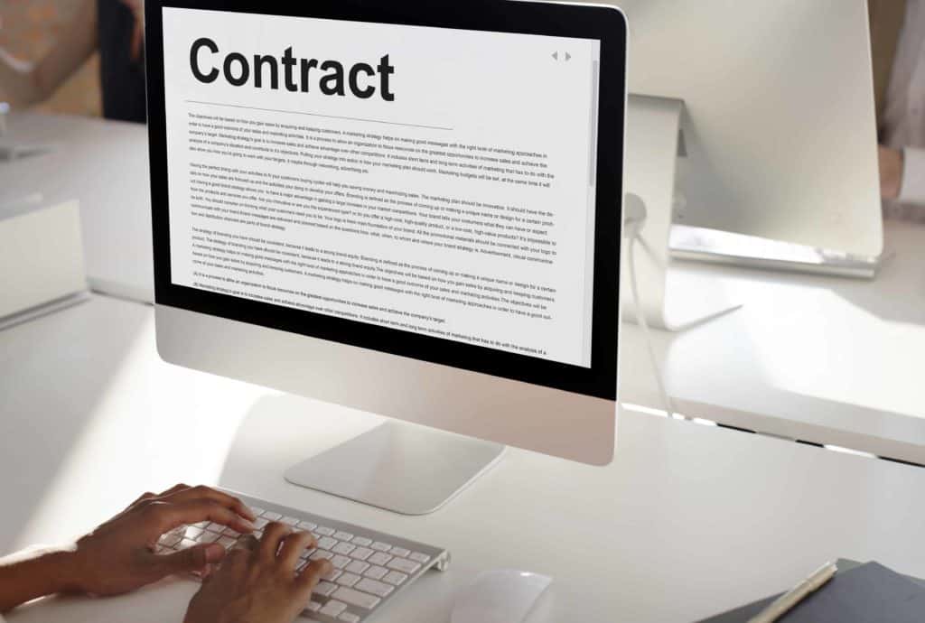 computer with a contract on screen