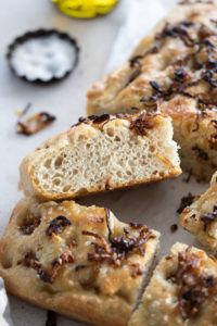 close up of focaccia cross cut on white counter