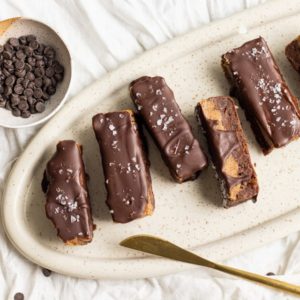 vegan milky way bars on a plate with a bowl of chocolate chips