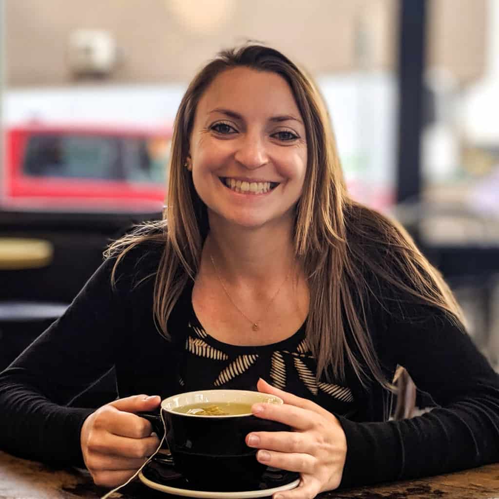 woman holding a coffee cup smiling