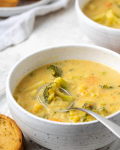 soup in a bowl with a piece of bread and a spoon