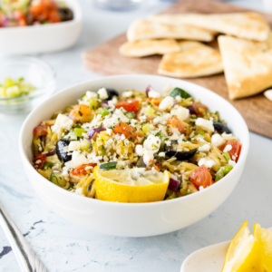 rice with toppings and a half lemon in a white bowl
