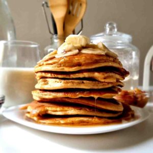 close up of a stack of gluten-free pancakes with banana slices