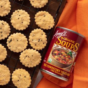 red can of amy's organic southwestern vegetable soup next to a rack of baked crackers