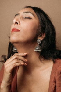 woman with brown hair looking upwards