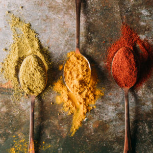 3 teaspoons filled with green, yellow, and red spices