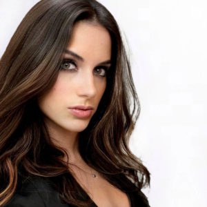 woman with brown hair looking at the camera