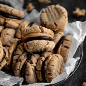 close up of a pile of cookie sandwiches with filling