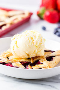 close up of a slice of pie with a scoop of vanilla ice cream