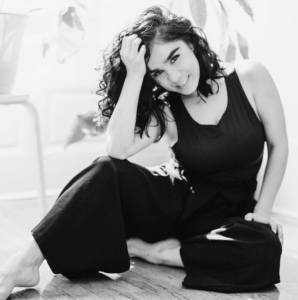 black and white photo of woman posing and smiling