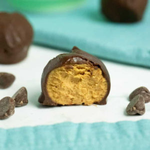 close up of sliced chocolate peanut butter energy balls bite with chocolate chips