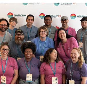 group of people posing and smiling towards the camera