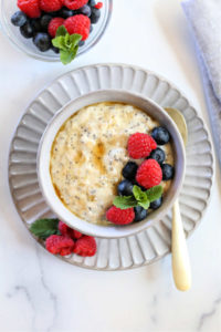overhead shot of a bowl of protein oatmeal with raspberries and blueberries