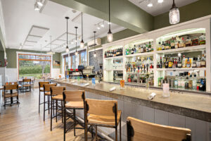 picture of a bar with wooden chairs and napkin set ups