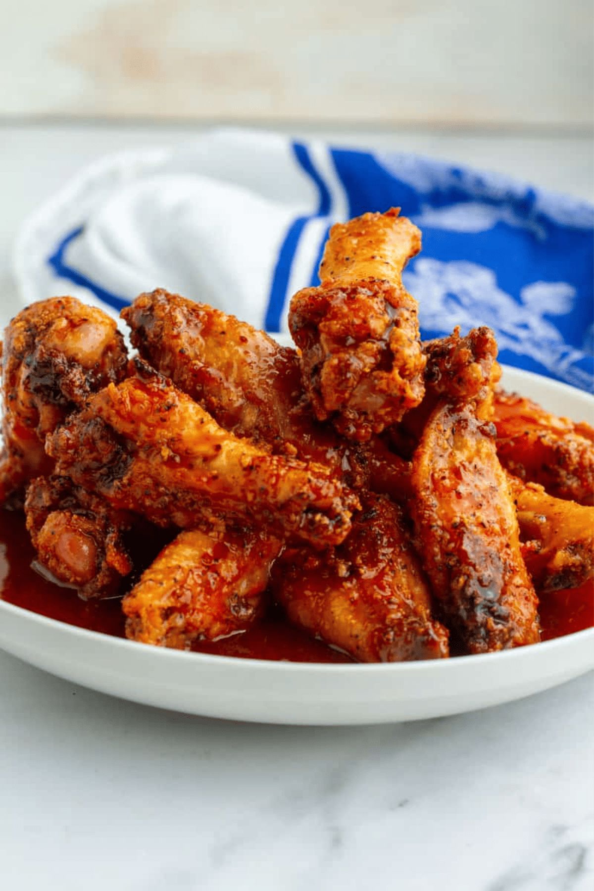 plate filled with chicken wings and a cloth napkin